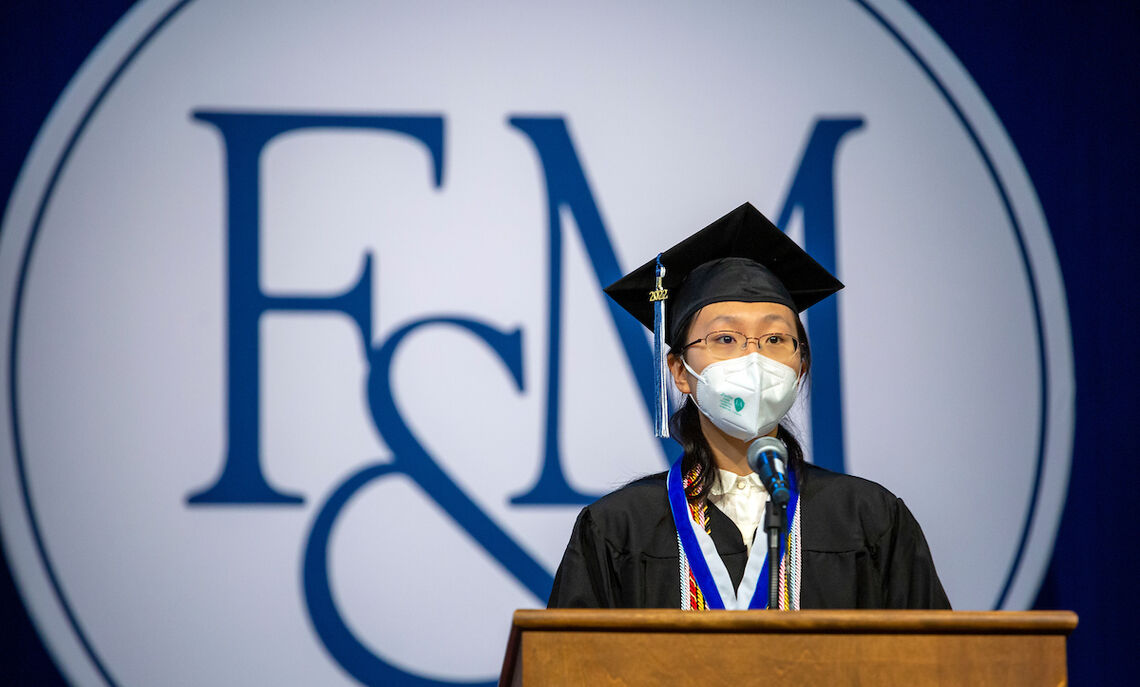 2022 Williamson Medalist Hailan Yu addresses her fellow classmates and friends and family gathered for Commencement in the Alumni Sports & Fitness Center at F&M.