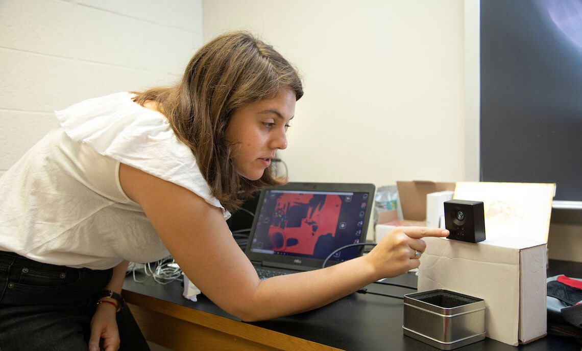 Gaby Sallai's work as a summer Hackman Scholar involves testing a laser and a "flight-of-time" camera for the four-wheeled robot.