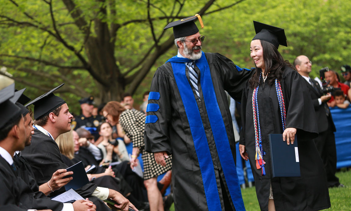 Ralph Taber, associate dean of the College and director of the Klehr Center for Jewish Life, congratulates Grace Jeong.
