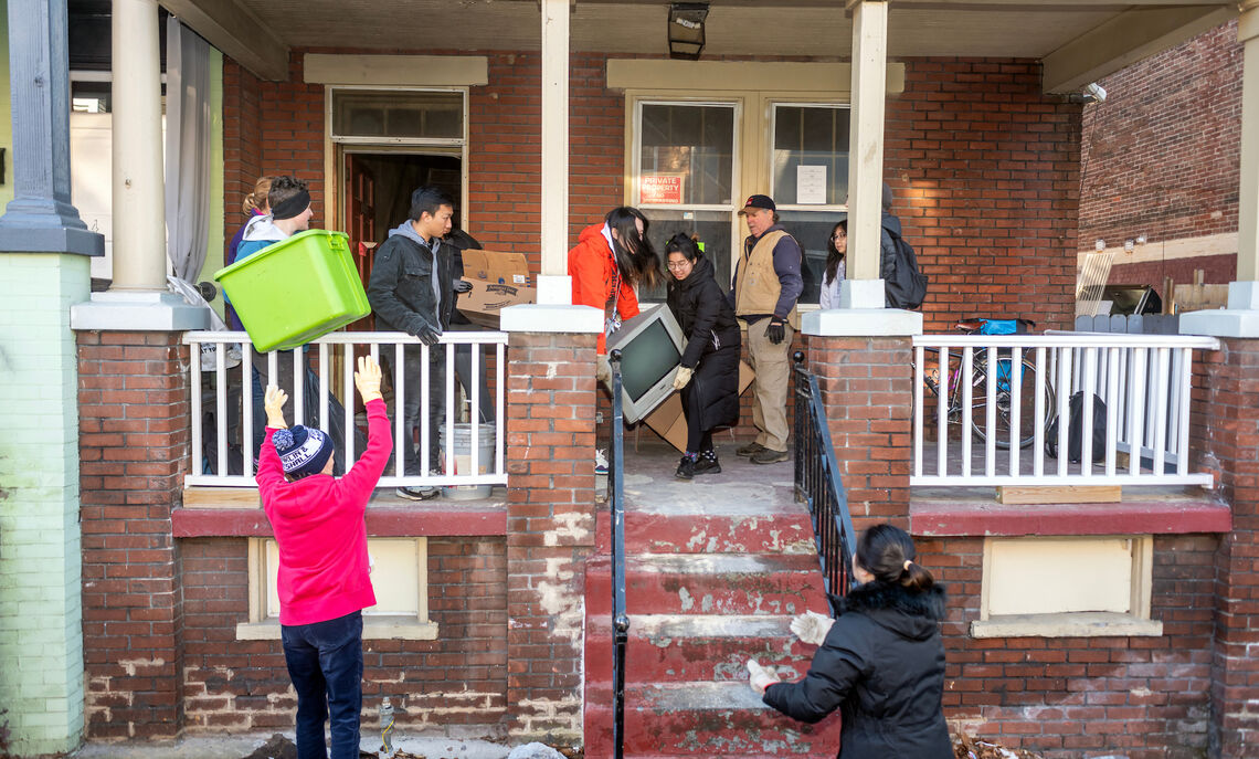 CRA volunteers remove garbage and debris from the property so that reconstruction work can begin.