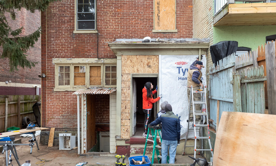 CRA volunteers get to work rehabilitating the property.