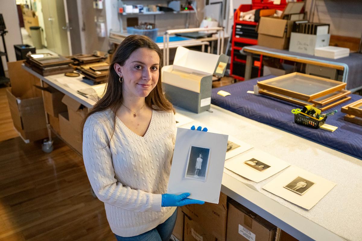 Student intern reviewing historic photographs