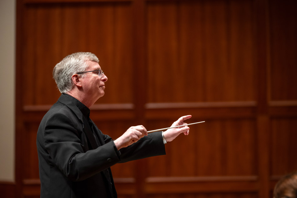 Brian Norcross leads the alumni orchestra