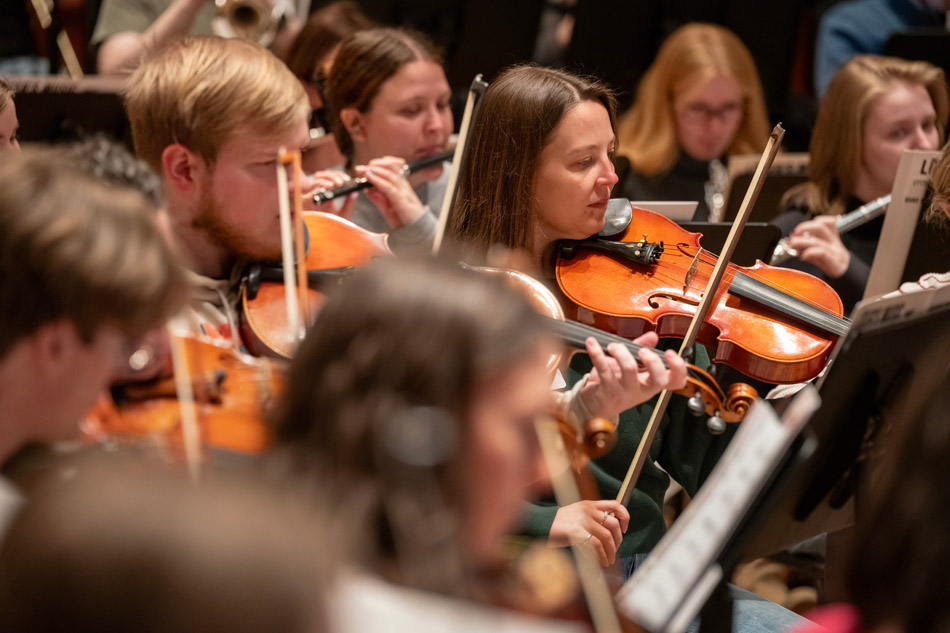 Brian Norcross leads the alumni orchestra