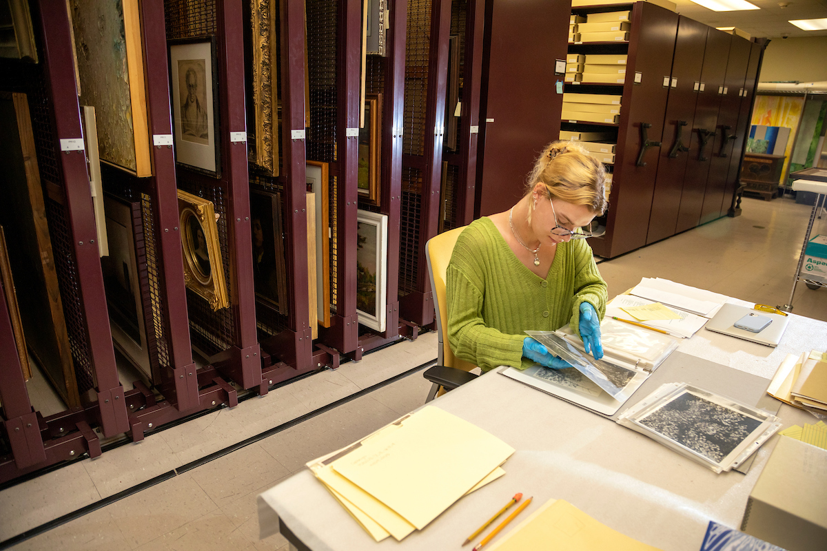 Student intern reviewing historic photographs