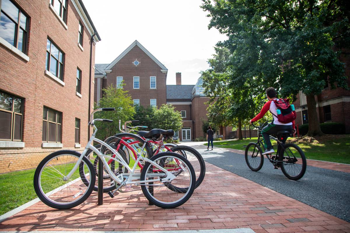 Student biking across campus