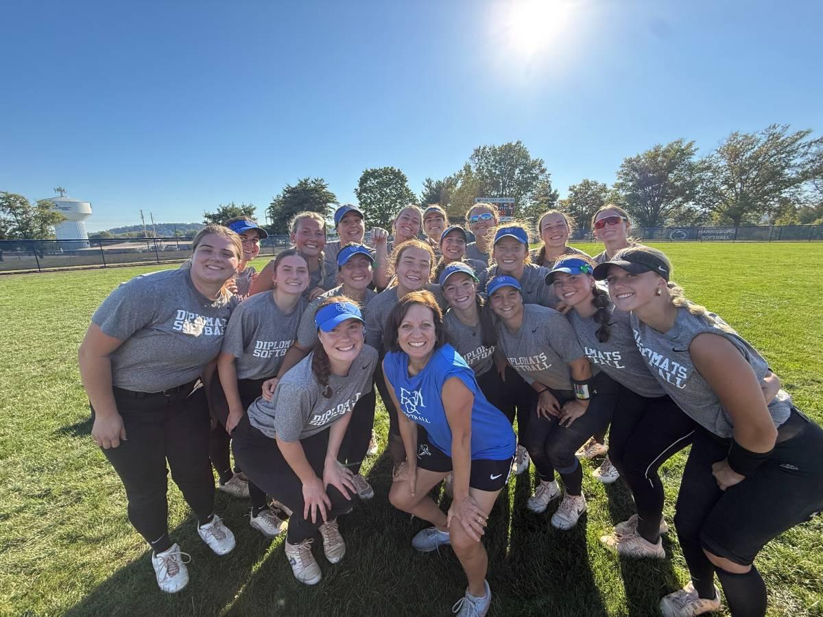 Dina Henry softball coach with team