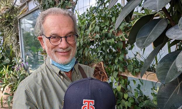 A photo of Rob Sternberg holding a baseball cap. 