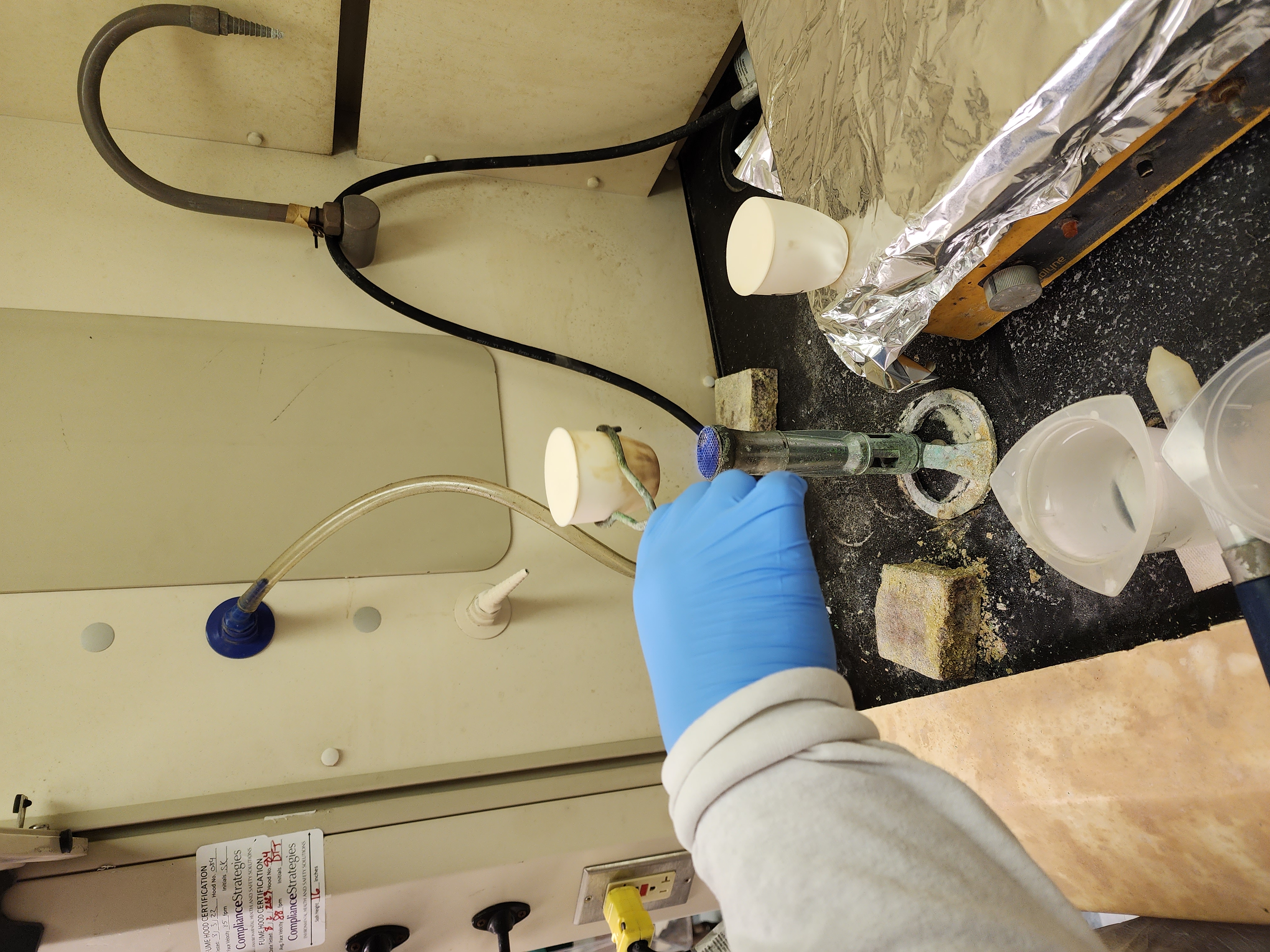 Lab technician Karen is heating the mixture of rock powder, sulfuric acid, and hydrofluoric acid