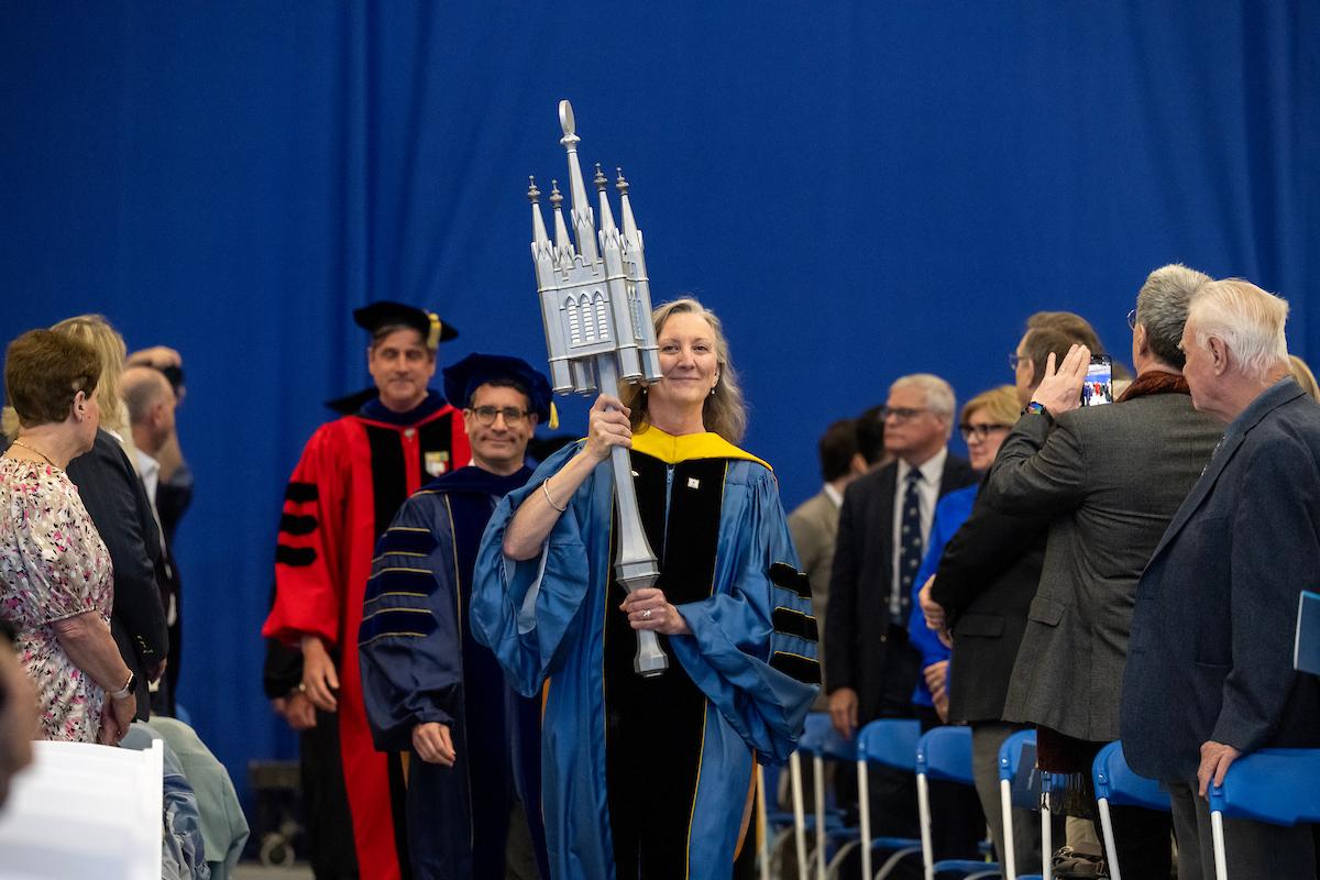 Barbara Nimersheim, professor of mathematics and chair of faculty council, carries the F&M mace. (Photo by Deb Grove)