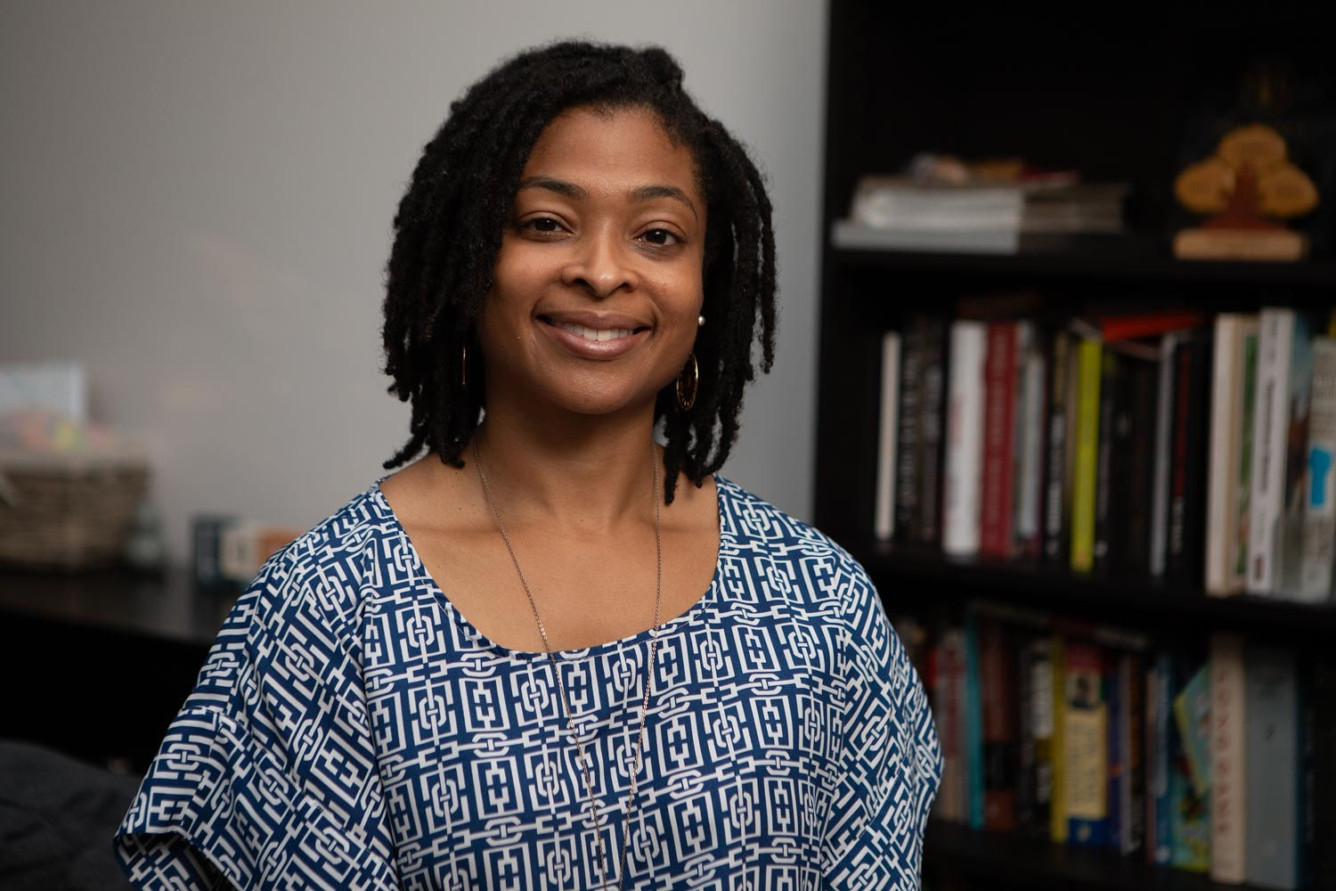 A photo of Nicole Jones Young in front of a bookcase. 