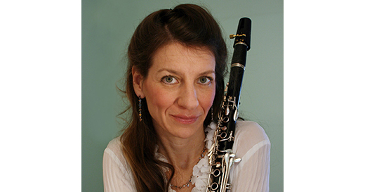 headshot for Doris Hall-Gulati over a sea green background with her clarinet