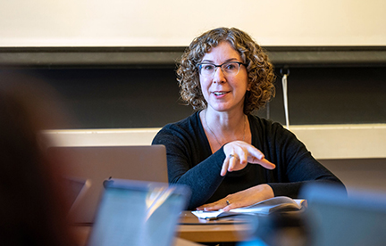 Professor Leistra-Jones in a classroom setting with a musical score before her
