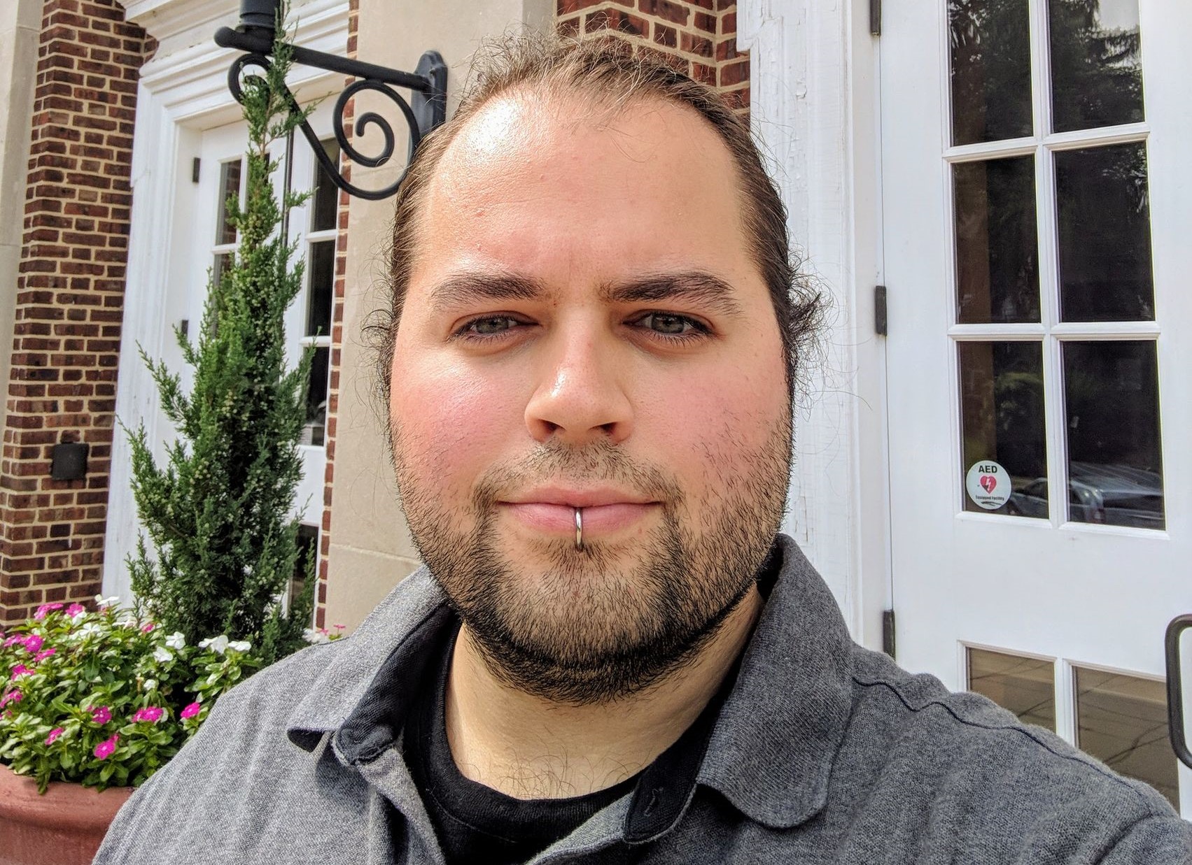 headshot of Travis Berkoski in front of Barshinger Center