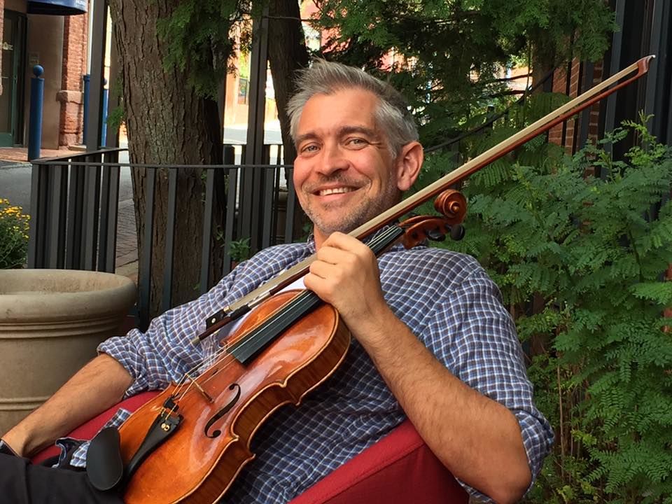Michael Jamanis with his violin pictured in downtown Lancaster
