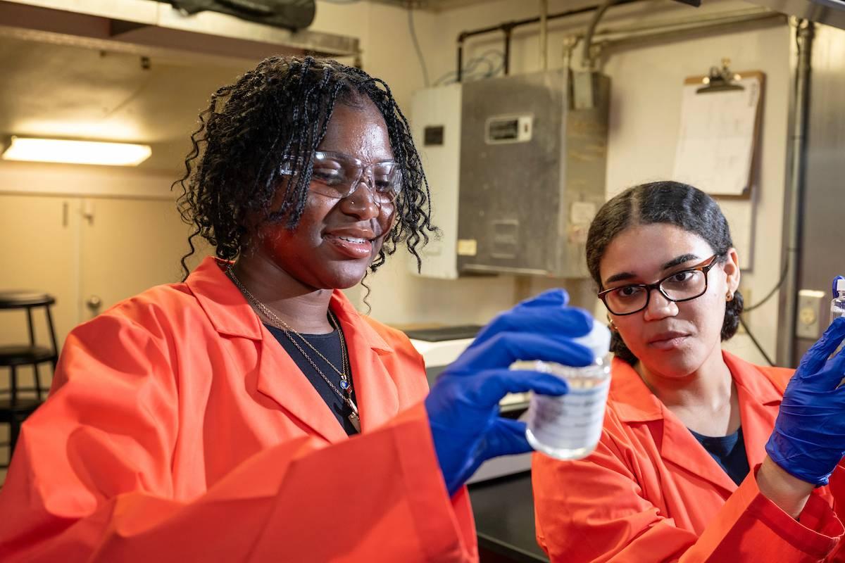 Testing water samples in bright lab coats. 