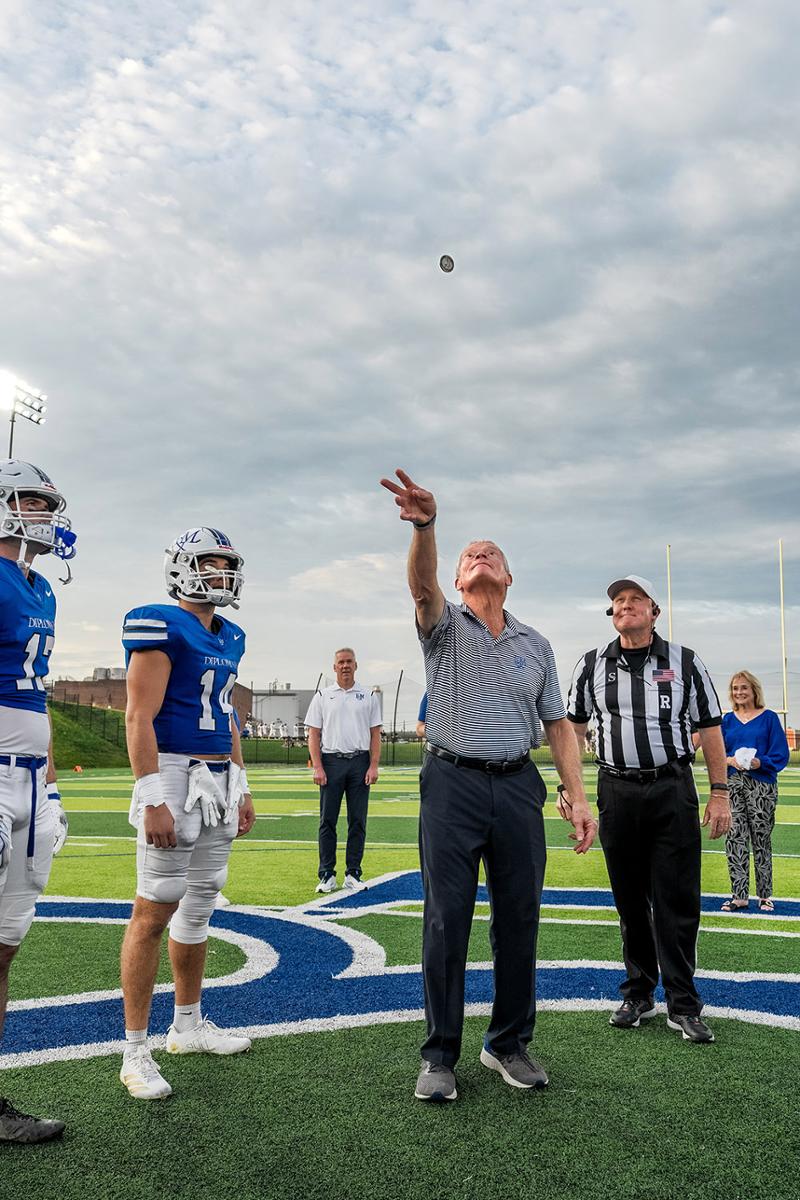 Larry Shadek '72 completes the honorary coin toss