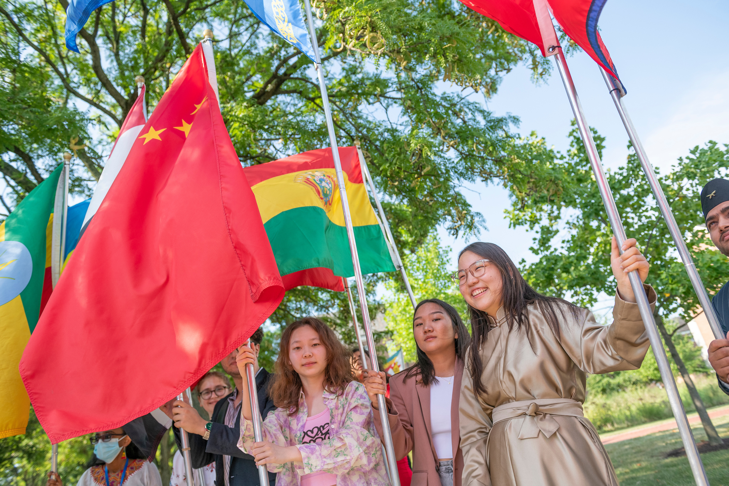 International students stand with their home countries' flags during F&M Convocation.