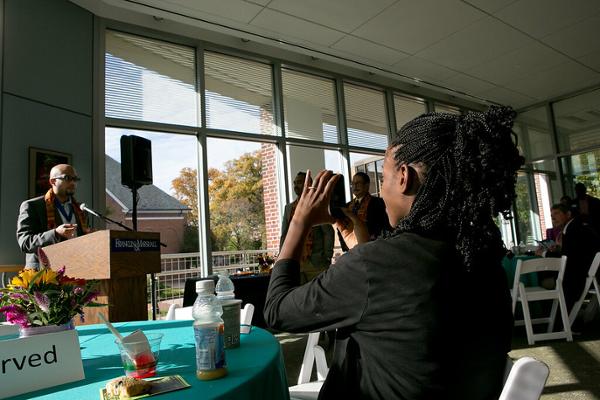Audience member snaps a photo of Aaron Bass during ceremony.