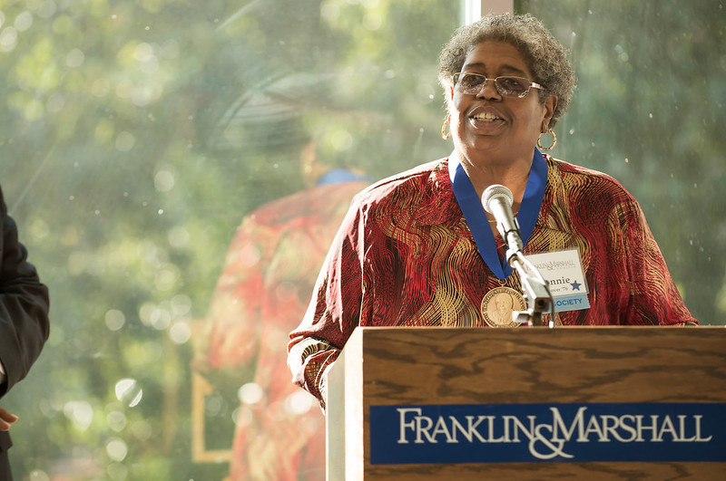 Donna Glover '76 speaks at a podium during the AAAC Bridgett Awards ceremony.