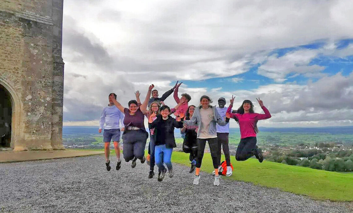 Students jump in air on a Bath field trip