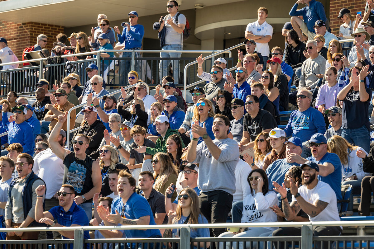 Crowd cheering on football team