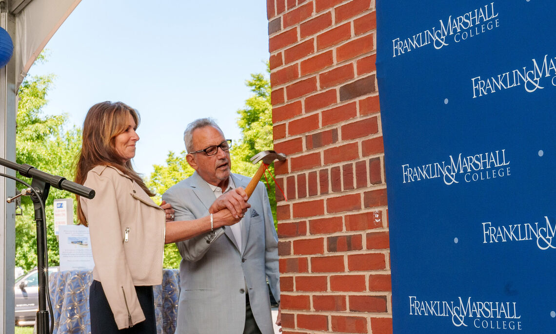 The celebration of the Lombardo Welcome Center featured traditional elements from Chinese feng shui principles. Using a ceremonial hammer, Sam and Dena Lombardo tapped on the southwest corner of the building, invoking good luck for the construction project.
