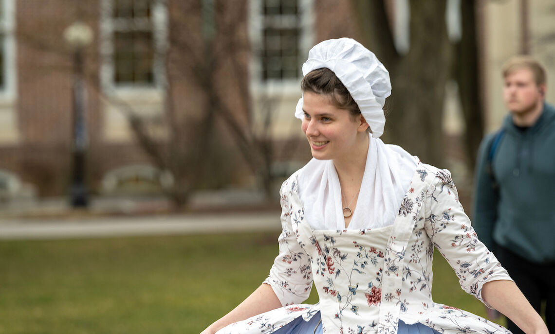Colonial girl in a modern world: Historic clothing designer Rachel Sheffield '20 takes a stroll on campus.