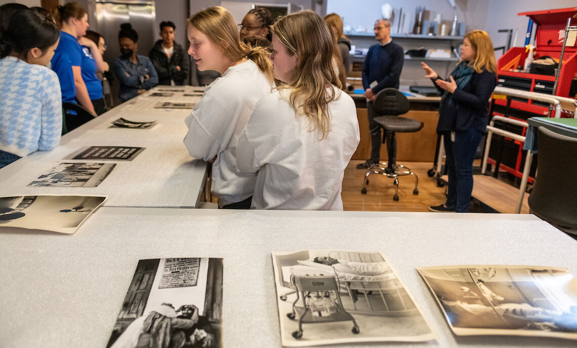 Students in Professor Di Giulio's "Narratives of Disability:" course examine a series of photos from the Phillips Museum collection that depict disability.