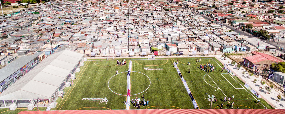 Over the summer, F&M soccer alumni from the Class of 2008 returned to Khayelitsha Township in Cape Town, where for the past decade they have developed a special relationship with
the community through the international language of soccer. The alumni visited Chris Campbell Memorial Field, a turf  eld and education center constructed in 2009 to honor the memory of F&M soccer standout Chris Campbell, who passed away before his senior season.
F&M men’s soccer Head Coach Dan Wagner says the facility has helped reduce crime in the area by 44 percent and helped improve the pass rate in local students’ math and English exams by 49 percent.
“These numbers have caught the attention of the South African government, which is trying to replicate the facility in other communities,” Wagner says. “Two more have already been created, with plans for 100 by the year 2030.”
The CTC Ten Foundation, an organization founded by the Campbell family to promote education and personal development of disadvantaged youth, created the  eld in partnership with F&M and local South African non-pro t AMANDLA EduFootball. “Many members of the F&M community have helped students invest in this community,” Wagner said. “That investment has made a difference in a country still trying to recover from apartheid."