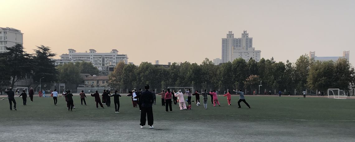 Wuhan residents practicing tai chi as the sun rises.