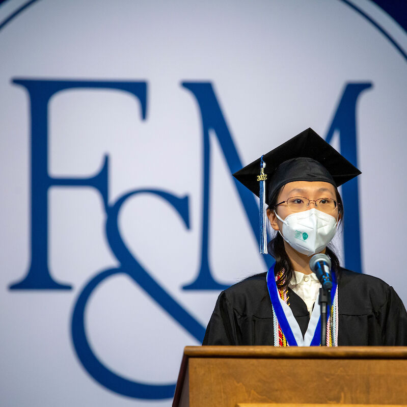 2022 Williamson Medalist Hailan Yu addresses her fellow classmates and friends and family gathered for Commencement in the Alumni Sports & Fitness Center at F&M.