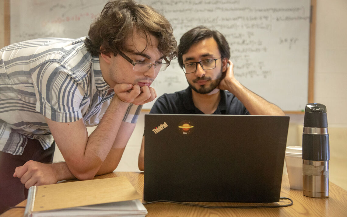 In this 2019 photo, Conor Larison '21 (left) and Faisal Alam '19 complete physics summer research.