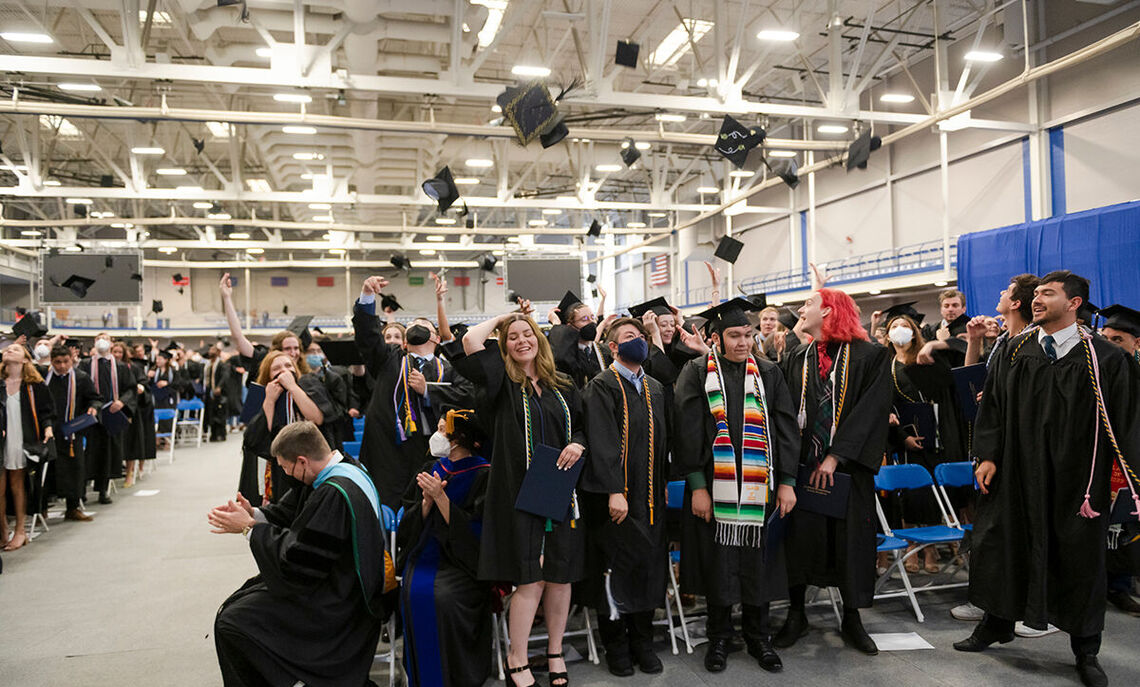 As is tradition, graduates celebrate their new status as young alumni of F&M by tossing their mortarboards skyward.
