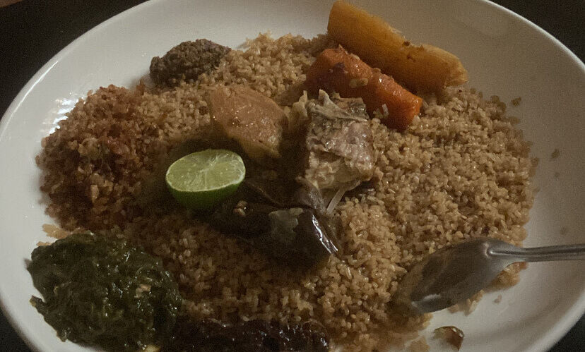 A Senegalese dish called Thiebou diene, made of fish, veggies, fried rice and a paste from spinach and tamarind on the side.