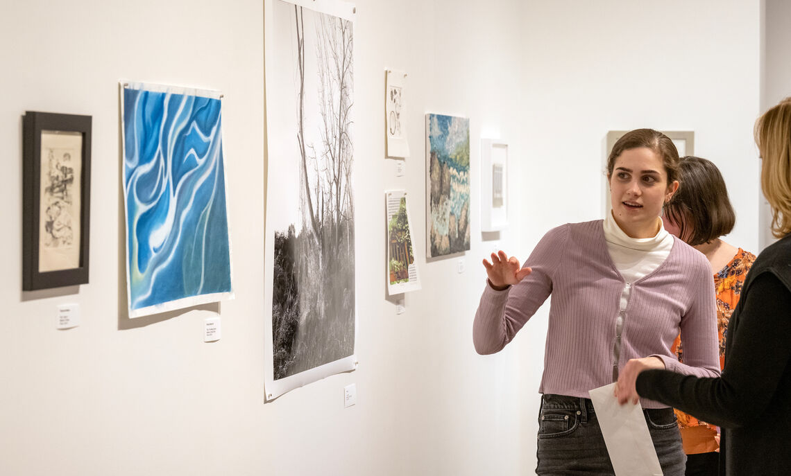 Therese Watkins '23 discusses her award-winning etching, "Tigers II," at the Winter72 Student Art Show in the Susan and Benjamin Winter Visual Arts Center.