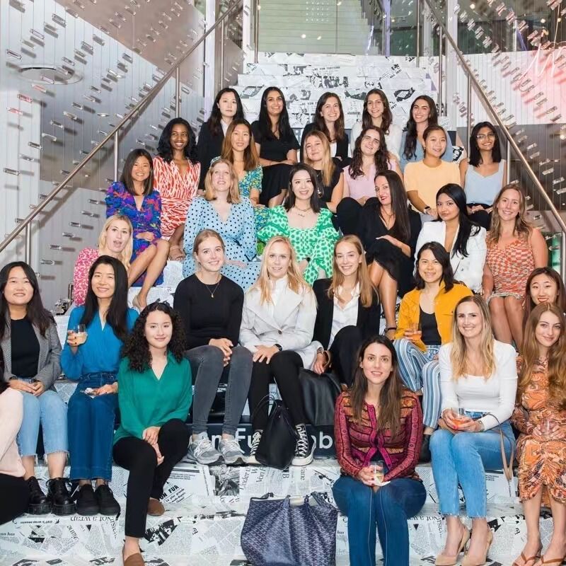 A group picture of Siwen Shen, Gabby Hirata '11, and their Diane von Furstenburg (DVF) colleagues. Shen is in the second row from the top, and is second from the left in the blue patterned dress. Gabby Hirata, F&M alumna and DVF president, is in the center of the photo (the third row from the top and the third one from the left, in the green dotted dress).