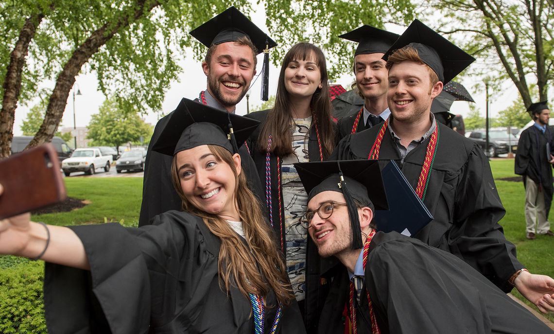 Following the ceremony, a group of graduates snaps a quick selfie outside the Alumni Sports & Fitness Center.