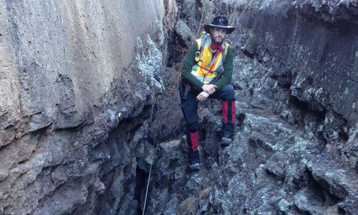 Jake Bleacher '00, NASA's  Chief Exploration Scientist, between a crevice in the lava flow.
