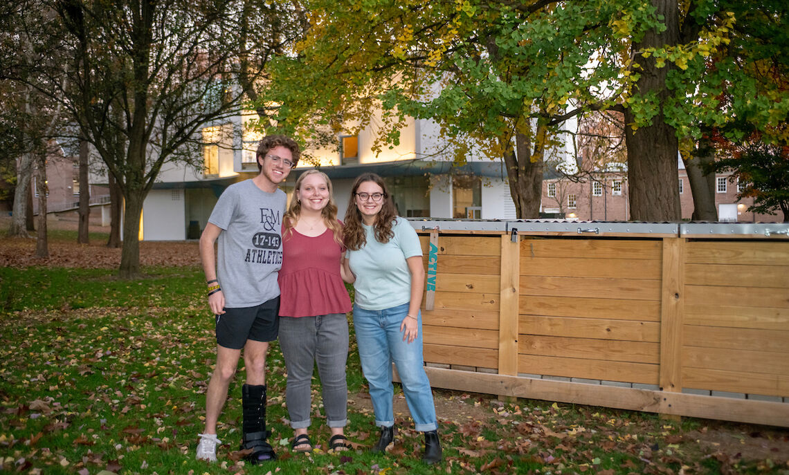 Bennett Wasch '23, Caroline Kleis '24 and Athena Kotsopriftis '25 discuss their involvement with Lancaster Composting Co-Ops. The Buchanan Park compost bin can be seen in the background.