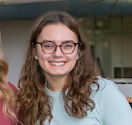 Bennett Wasch '23, Caroline Kleis '24 and Athena Kotsopriftis '25 discuss their involvement with Lancaster Composting Co-Ops. The Buchanan Park compost bin can be seen in the background.