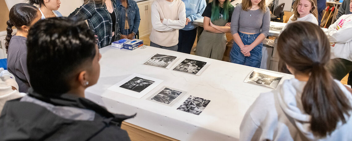 Students examining photos depicting disability.