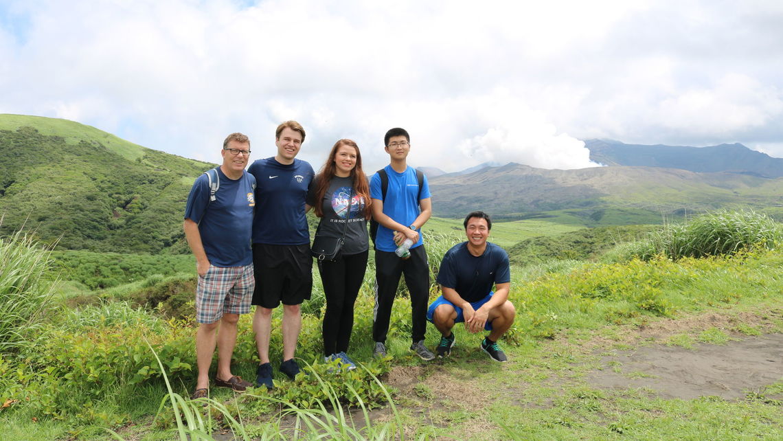 Professor Crawford and students visit the island of Kyushu's Mount Aso. This volcano erupted while they were there;  smoke pours from the crater.