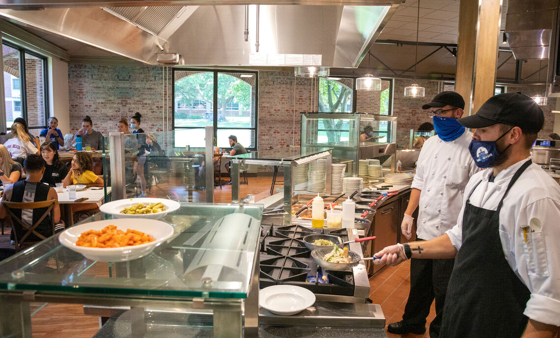 Chefs cook up a pasta dish at the remodeled and expanded grill station.