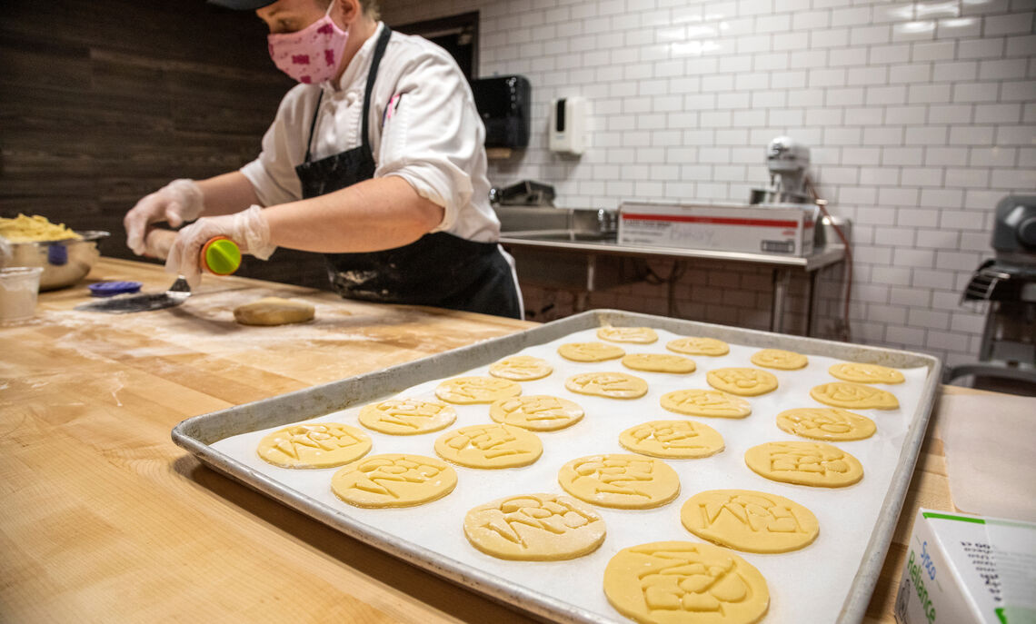 The open-air bakery allows diners to watch the bakers as they prepare fresh goods daily.