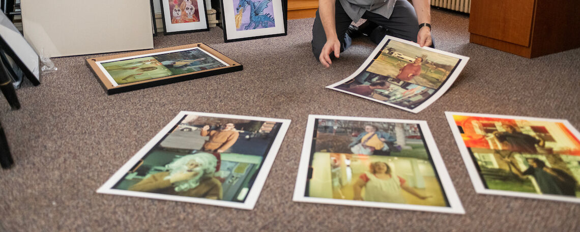 In his campus office, Hollenbaugh displays some of the works in the March 3-31 exhibit at the Susan and Benjamin Winter Visual Arts Center .