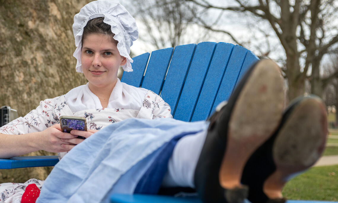 Colonial girl in a modern world: Historic clothing designer Rachel Sheffield '20 takes a break on campus.