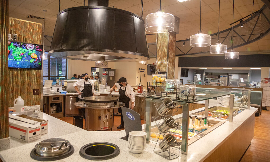 Chefs prepare meals at the popular Mongolian Grill station.