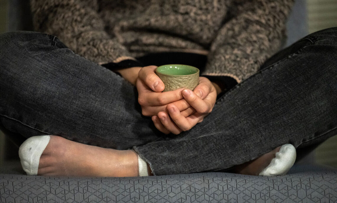 Students enjoys tea and conversation after a weekly meditation session.