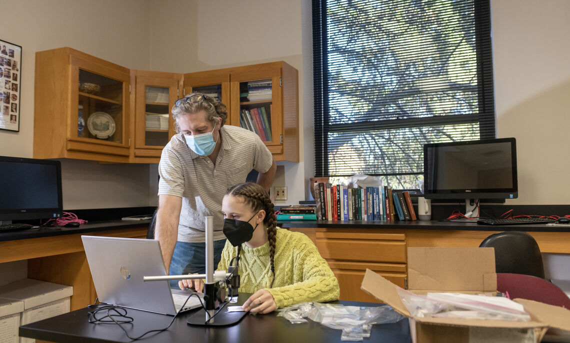 In F&M's archaeology lab, Fortier examines more closely some of the burned animal bones with Professor Smith.